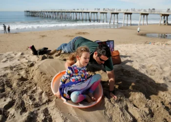 Christmas on the beach in Southern California, as rest of country copes with monster winter storm
